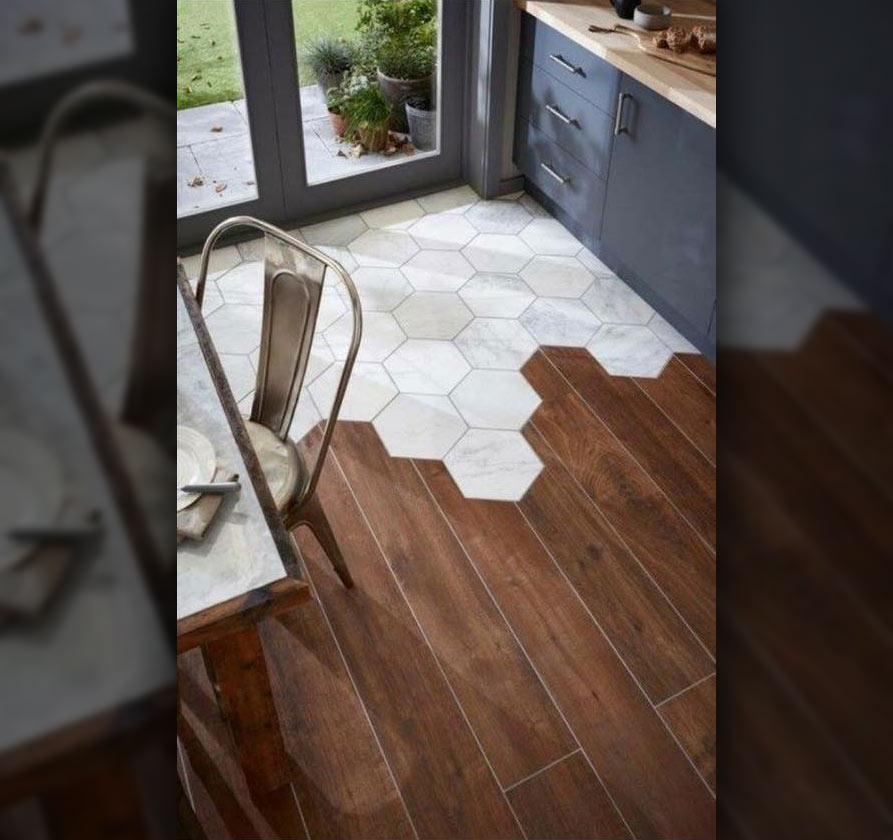 Modern kitchen floor with a combination of white tile and hardwood flooring.